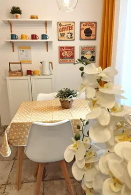 a dining room table with a white chair and a plant at Angolo Romano in Rome