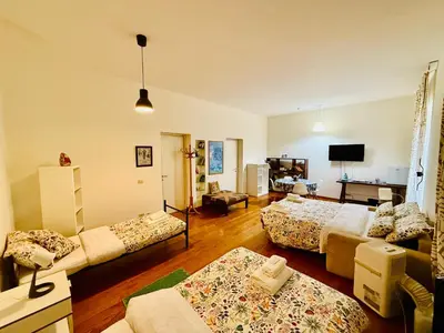a living room with two beds and a couch at TURATI ROOMs in Rome