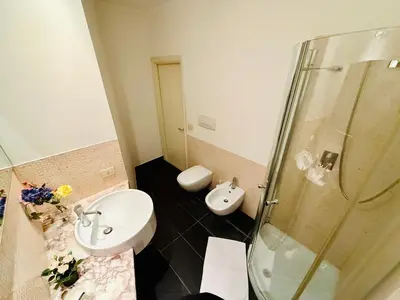 a bathroom with a toilet and a sink and a shower at TURATI ROOMs in Rome
