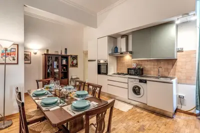 a kitchen and dining room with a table and chairs at Fresh House Ludovisi in Rome