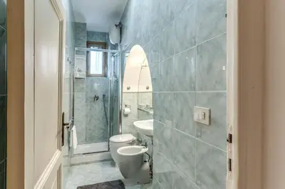 a bathroom with a toilet and a sink at Fresh House Ludovisi in Rome