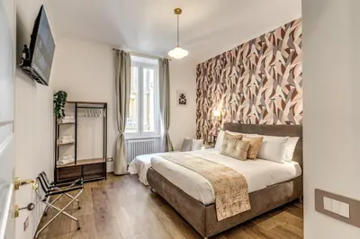 a bedroom with a bed and a large window at Casa Bixio Fantastico appartamento nel cuore di Roma in Rome