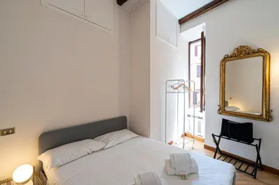a white bedroom with a bed and a mirror at Margana Luxury 3 bedrooms amazing terrace in Rome