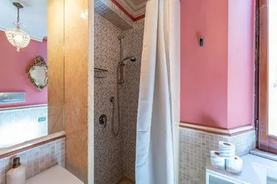a bathroom with a shower with a shower curtain at Margana Luxury 3 bedrooms amazing terrace in Rome