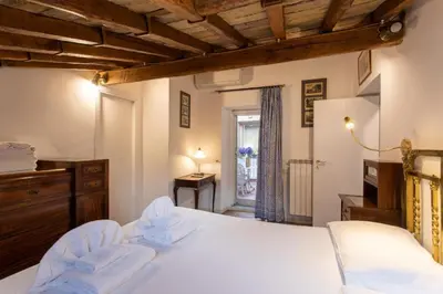 a bedroom with a white bed and a window at Cozy Gambero Apartments in Rome