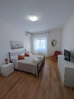 a bedroom with a bed and a television in it at Da Tony vicino San Pietro in Rome