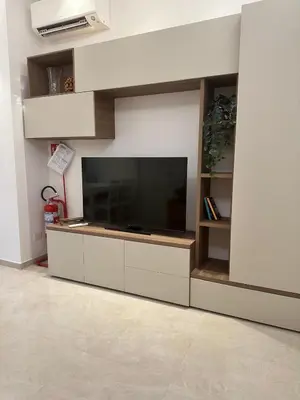 a living room with a large entertainment center with a flat screen tv at Welcome to Campo De' Fiori in Rome
