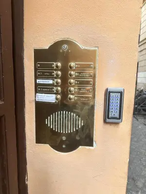a close up of a metal door with a remote control at Welcome to Campo De' Fiori in Rome