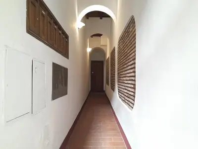 a hallway with paintings on the walls of a building at Suite METRO Cavour 200m Coliseum in Rome