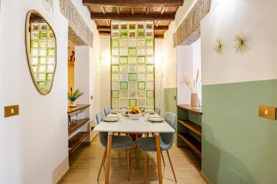 a dining room with a white table and chairs at Suite METRO Cavour 200m Coliseum in Rome