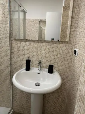a bathroom with a white sink and a mirror at Imperial Apartment in Rome
