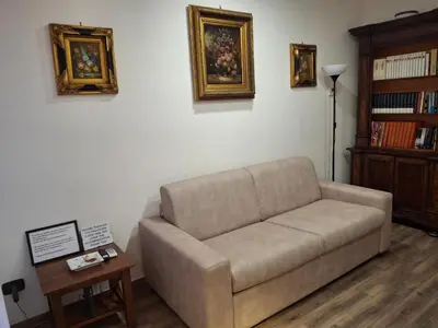 a living room with a couch and a table at Imperial Apartment in Rome