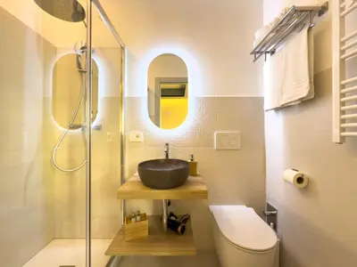 a bathroom with a sink and a glass shower at Vatican Domus Stefania Guest House in Rome