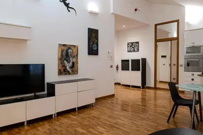 a living room with a flat screen tv on a wall at Restart Accommodations Dea Roma in Rome