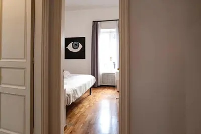 a bedroom with a white bed and a window at Restart Accommodations Dea Roma in Rome