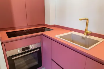 a kitchen with pink cabinets and a sink at Spanish Steps Exclusive 3BDR in Rome