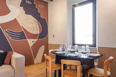 a dining room with a table with wine glasses on it at Spanish Steps Exclusive 3BDR in Rome