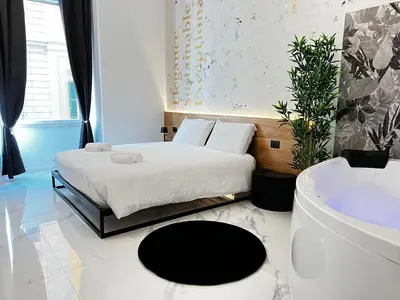 a bedroom with a bed and a bath tub at ESE luxury spa suites - Private Jacuzzi Rooms Near Termini, Perfect for Winter in Rome