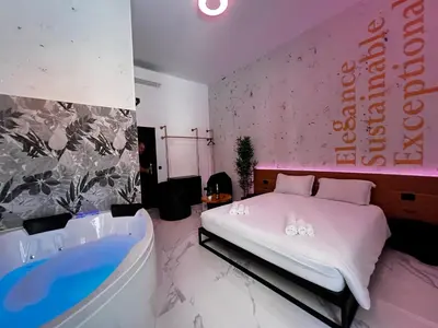 a bedroom with a bed and a bath tub at ESE luxury spa suites - Private Jacuzzi Rooms Near Termini, Perfect for Winter in Rome