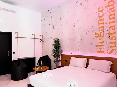 a bedroom with a white bed and a pink wall at ESE luxury spa suites - Private Jacuzzi Rooms Near Termini, Perfect for Winter in Rome