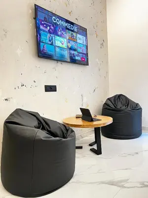 a room with a table and two chairs and a tv at ESE luxury spa suites - Private Jacuzzi Rooms Near Termini, Perfect for Winter in Rome