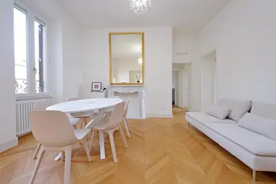 a white living room with a white table and chairs at Vatican Basilica Apartment in Rome