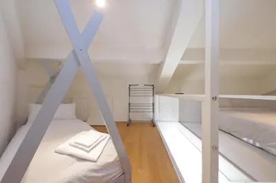 a room with two bunk beds and a ladder at Vatican Basilica Apartment in Rome