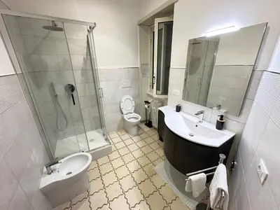 a bathroom with a sink and a shower and a toilet at La casa di Ezechiele in Rome