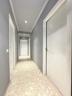 an empty corridor with an open door in a house at La casa di Ezechiele in Rome