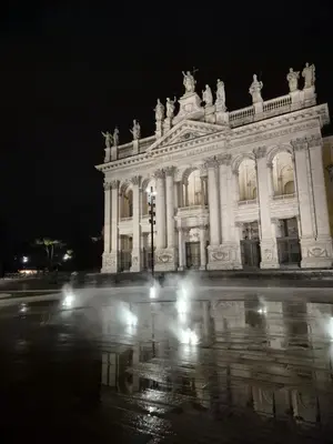 a large white building at night with lights at San Giovanni Living House 2 in Rome