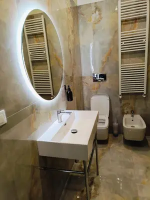 a bathroom with a sink and a toilet and a mirror at Cozy Luxury room San Pietro in Rome