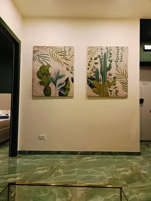 three paintings on a wall in a room at Cozy Luxury room San Pietro in Rome