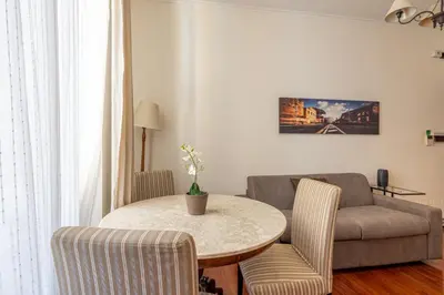 a living room with a table and a couch at La Tua Casa al Colosseo in Rome