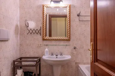 a bathroom with a sink and a mirror at La Tua Casa al Colosseo in Rome