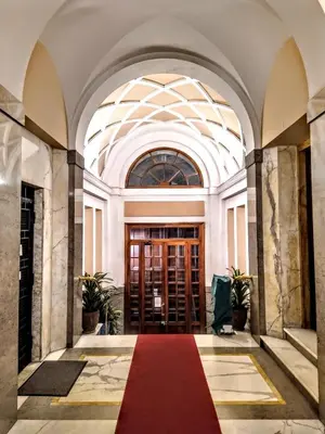a hallway with a red carpet in a building at GH Lorvand in Rome