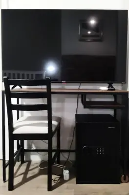 a computer desk with a chair and a computer monitor at GH Lorvand in Rome