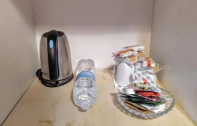 a bottle of water sitting on a counter next to a blender at GH Lorvand in Rome