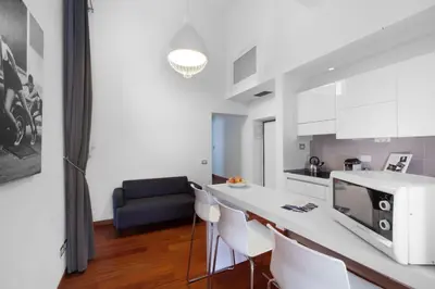 a kitchen with a counter and a table with chairs at Oriana Homèl Roma in Rome