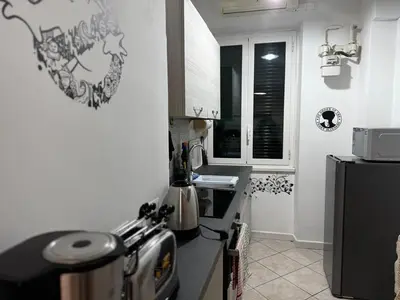 a kitchen with a refrigerator and a counter top at cosy apt close to metro San Paolo in Rome