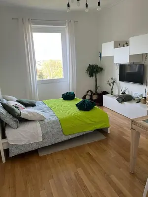 a bedroom with a bed with a green blanket at Apartment in the heart of Rome in Rome