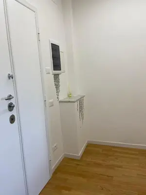 a white room with a television on a wall at Apartment in the heart of Rome in Rome