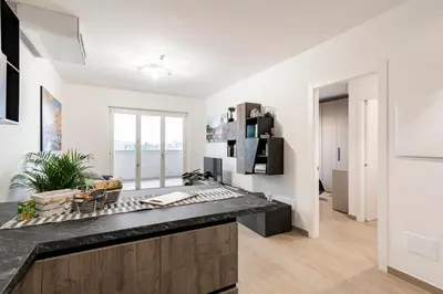 a kitchen with white walls and a black counter top at Private Parking - Bilocale Monti Tiburtini in Rome