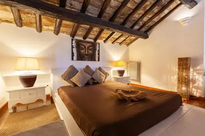 a bedroom with a large bed with a statue on it at Piazza Navona Loft for 7 people in Rome