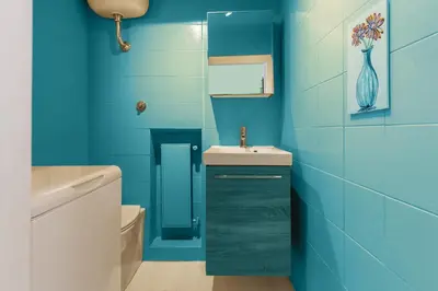 a blue bathroom with a sink and a toilet at Piazza Navona Loft for 7 people in Rome