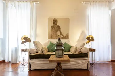 a living room with a couch with pillows at Piazza Navona Loft for 7 people in Rome
