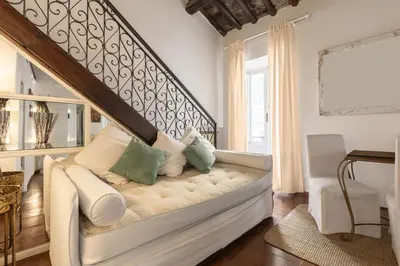 a living room with a white couch with pillows at Piazza Navona Loft for 7 people in Rome