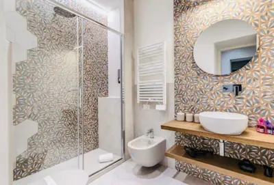 a bathroom with a shower and a sink and a mirror at Rome at Home in Rome