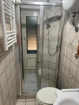 a bathroom with a shower with a toilet and a sink at Apartment Dacia Colosseum in Rome