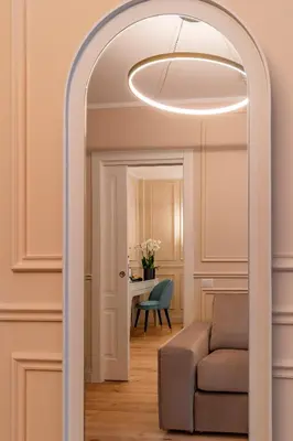 an archway in a living room with a couch and a table at Trevi Imperial Suite 3 in Rome