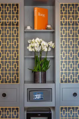 a vase of flowers on a shelf in a room at Trevi Imperial Suite 3 in Rome